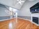 Living room with hardwood floors, fireplace, and views to the kitchen and stairs at 615 Real Quiet Ct, York, SC 29745