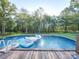 Above ground pool with inflatable floats and wooden deck at 615 Real Quiet Ct, York, SC 29745