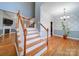 Open staircase with wooden railing and hardwood floors at 615 Real Quiet Ct, York, SC 29745