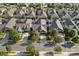 Aerial view of a residential area with neat rows of gray-roofed homes, mature trees, and green lawns at 16115 Lakeside Loop Ln, Cornelius, NC 28031