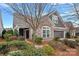 Charming home with stone and siding exterior, well-maintained landscaping, and an attached two-car garage at 16115 Lakeside Loop Ln, Cornelius, NC 28031