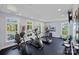 An exercise room offers modern fitness equipment and bright natural light from its large windows at 16115 Lakeside Loop Ln, Cornelius, NC 28031