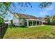 Backyard view of house with large sunroom addition at 2024 Holly Villa Cir, Indian Trail, NC 28079