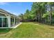 Backyard view of house with large sunroom addition at 2024 Holly Villa Cir, Indian Trail, NC 28079