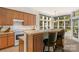 Breakfast bar and kitchen with a view to backyard at 2024 Holly Villa Cir, Indian Trail, NC 28079