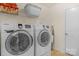 Bright laundry room, features Samsung washer and dryer, and ample shelving at 2024 Holly Villa Cir, Indian Trail, NC 28079