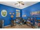 Home office with blue walls, built-in shelving, and window at 2024 Holly Villa Cir, Indian Trail, NC 28079