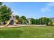 Community playground with swings and play equipment at 2024 Holly Villa Cir, Indian Trail, NC 28079