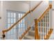 Wooden staircase with white railings and frosted glass doors at 2024 Holly Villa Cir, Indian Trail, NC 28079