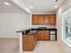 Wet bar featuring custom wood cabinetry, granite countertop, and a stainless steel refrigerator at 3015 Duclair Ln, Fort Mill, SC 29707