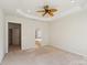 Main bedroom with ceiling fan and access to bathroom at 3015 Duclair Ln, Fort Mill, SC 29707