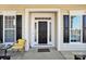 Inviting front entry with black door and yellow chair at 3015 Duclair Ln, Fort Mill, SC 29707