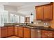 Modern kitchen with stainless steel dishwasher and breakfast bar at 3015 Duclair Ln, Fort Mill, SC 29707