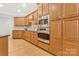 Well-equipped kitchen with stainless steel appliances, wooden cabinets and hardwood floors at 3015 Duclair Ln, Fort Mill, SC 29707