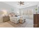 Inviting main bedroom showcases a tray ceiling, two windows, neutral colors, and matching bedside tables at 3015 Duclair Ln, Fort Mill, SC 29707