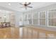 Bright sunroom with large windows, hardwood floors, and access to outdoor space at 3015 Duclair Ln, Fort Mill, SC 29707