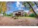 Two-story home with neutral siding features a backyard deck and lower level walk-out; surrounded by trees and lawn at 138 Huntly Ln, Mooresville, NC 28115