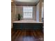 Bathroom featuring walk-in shower and platform soaking tub with wood-look tile flooring at 138 Huntly Ln, Mooresville, NC 28115