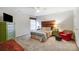 Cozy bedroom featuring a wood accent wall, colorful textiles, and cozy red armchair at 138 Huntly Ln, Mooresville, NC 28115