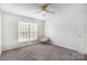 Bright bedroom with two windows, plush carpet, neutral walls, and comfortable armchair at 138 Huntly Ln, Mooresville, NC 28115