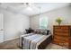 Neutral bedroom with window view, wood dresser, a comfortable bed, and carpeted floors at 138 Huntly Ln, Mooresville, NC 28115