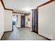 Hallway with light grey floors, wood trim, and unique decor leading into the living room at 138 Huntly Ln, Mooresville, NC 28115