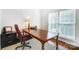 Well-lit home office with hardwood floors, a traditional wooden desk, and ample natural light at 138 Huntly Ln, Mooresville, NC 28115