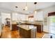 Spacious kitchen featuring granite countertops, an island, stainless steel appliances, and hardwood floors at 138 Huntly Ln, Mooresville, NC 28115