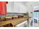 Laundry room features a butcher block countertop, a washer and dryer, and overhead white cabinets at 138 Huntly Ln, Mooresville, NC 28115