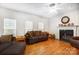 Bright living room featuring a fireplace, hardwood floors, and large windows at 138 Huntly Ln, Mooresville, NC 28115