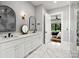 Modern bathroom boasts double vanity, marble floors, and a large walk-in shower at 2109 Goose Creek Farm Ln, Indian Trail, NC 28079