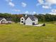 View of the home's side elevation showcasing a large backyard at 2109 Goose Creek Farm Ln, Indian Trail, NC 28079