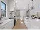 White kitchen with marble backsplash, island, and stainless steel appliances at 2109 Goose Creek Farm Ln, Indian Trail, NC 28079