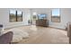 Light-filled living room with hardwood floors and large windows at 2109 Goose Creek Farm Ln, Indian Trail, NC 28079