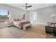 Spacious main bedroom with hardwood floors, a ceiling fan, large windows, and an ensuite bathroom at 2109 Goose Creek Farm Ln, Indian Trail, NC 28079