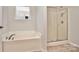 Bathroom with corner bathtub and separate shower at 3308 Lemongrass Ln, Charlotte, NC 28214