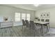 Virtually staged dining room with gray chairs and a marble-top table at 3308 Lemongrass Ln, Charlotte, NC 28214