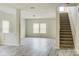 Open living area with staircase and gray vinyl plank flooring at 3308 Lemongrass Ln, Charlotte, NC 28214