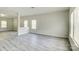 Open living area with gray vinyl plank flooring and neutral walls at 3308 Lemongrass Ln, Charlotte, NC 28214