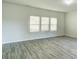 Living room with gray vinyl plank flooring and neutral walls at 3308 Lemongrass Ln, Charlotte, NC 28214