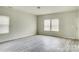 Spacious living room with gray vinyl plank flooring and neutral walls at 3308 Lemongrass Ln, Charlotte, NC 28214