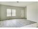 Bright living room with neutral walls and gray vinyl plank flooring at 3308 Lemongrass Ln, Charlotte, NC 28214