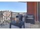 Inviting balcony featuring comfortable seating, brick accents, and city views at 300 W 5Th St # 402, Charlotte, NC 28202