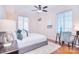 Bedroom featuring windows, neutral decor, a ceiling fan, and hardwood flooring at 300 W 5Th St # 402, Charlotte, NC 28202