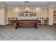 Relaxing billiard room with vintage style billiard lights, dark stained pool table and wall art at 300 W 5Th St # 402, Charlotte, NC 28202