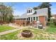 Brick home with a large backyard, patio, and fire pit at 515 S Academy St, Lincolnton, NC 28092