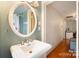 Small bathroom with pedestal sink and shower at 515 S Academy St, Lincolnton, NC 28092