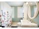 Bathroom with floral shower curtain, pedestal sink, and window at 515 S Academy St, Lincolnton, NC 28092