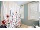 Bright bathroom with floral shower curtain and window at 515 S Academy St, Lincolnton, NC 28092