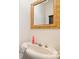 Small bathroom with pedestal sink and ornate mirror at 515 S Academy St, Lincolnton, NC 28092
